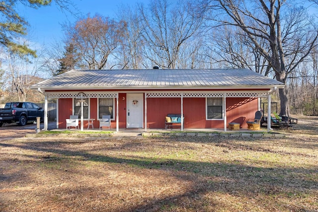 view of front of house featuring metal roof and a porch