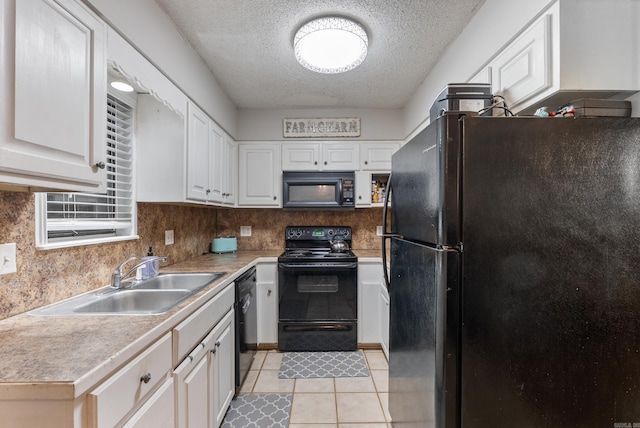 kitchen with black appliances, white cabinetry, light countertops, and a sink