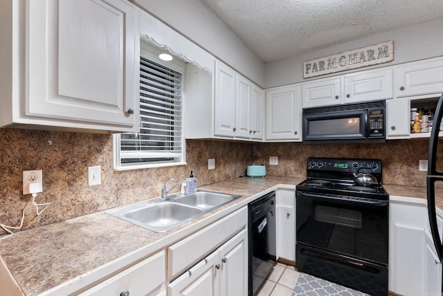 kitchen featuring white cabinetry, a sink, black appliances, and light tile patterned flooring