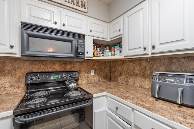 kitchen with black appliances, white cabinets, and decorative backsplash