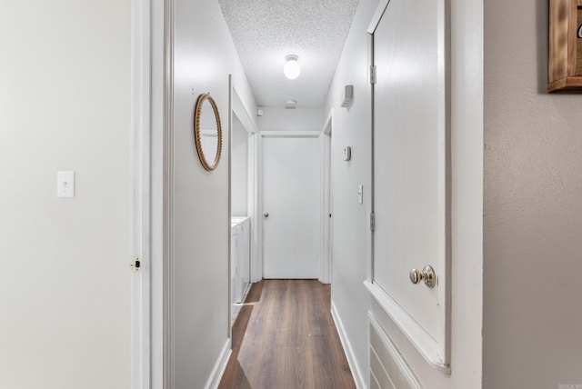 corridor featuring dark wood finished floors and a textured ceiling