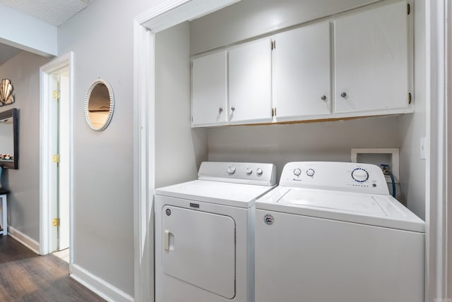 laundry room with dark wood-style floors, cabinet space, independent washer and dryer, and baseboards