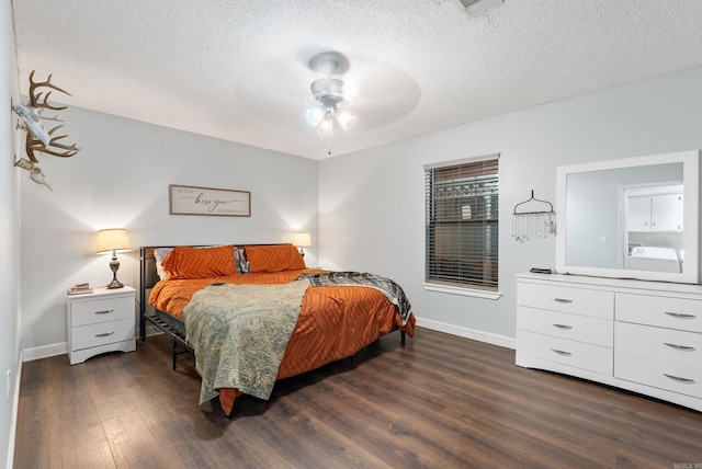 bedroom featuring dark wood-style floors, ceiling fan, a textured ceiling, and baseboards