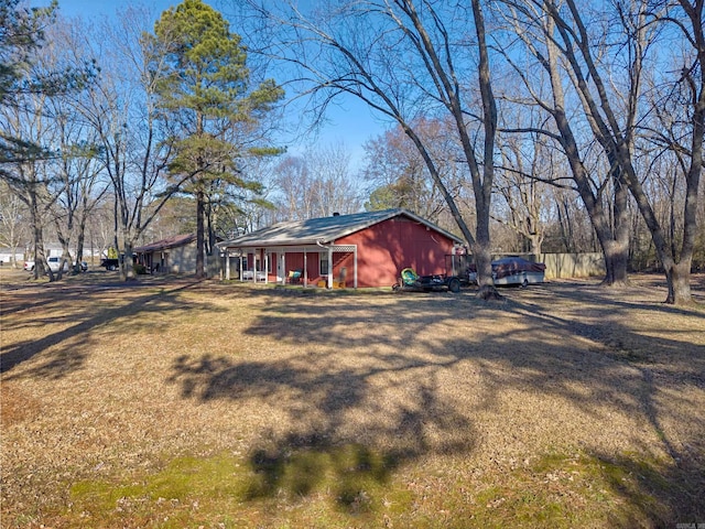 view of property exterior featuring a lawn and fence