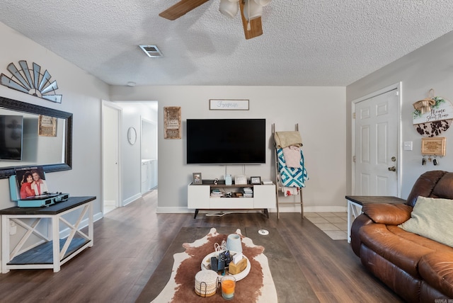 living area with visible vents, ceiling fan, a textured ceiling, and wood finished floors