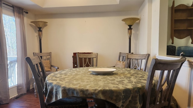 dining area featuring dark wood-style flooring, visible vents, and plenty of natural light