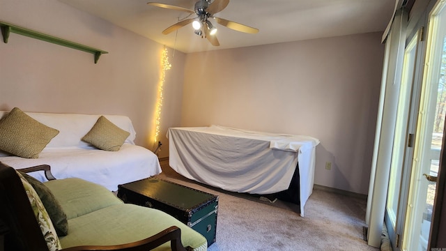 carpeted bedroom featuring a ceiling fan and baseboards