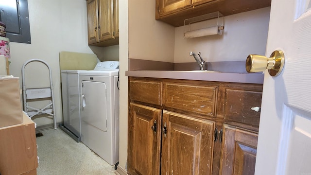 laundry room featuring electric panel, cabinet space, and washing machine and clothes dryer