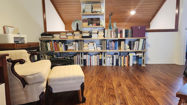 living area with lofted ceiling, wood finished floors, wood ceiling, and baseboards