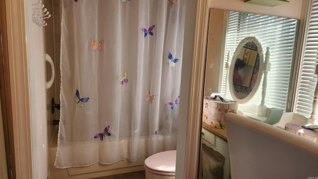 bathroom with toilet and shower / bathtub combination with curtain