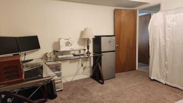 kitchen featuring carpet flooring and freestanding refrigerator