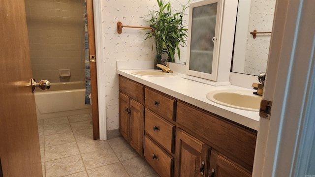 bathroom with double vanity, tile patterned flooring, a sink, and wallpapered walls