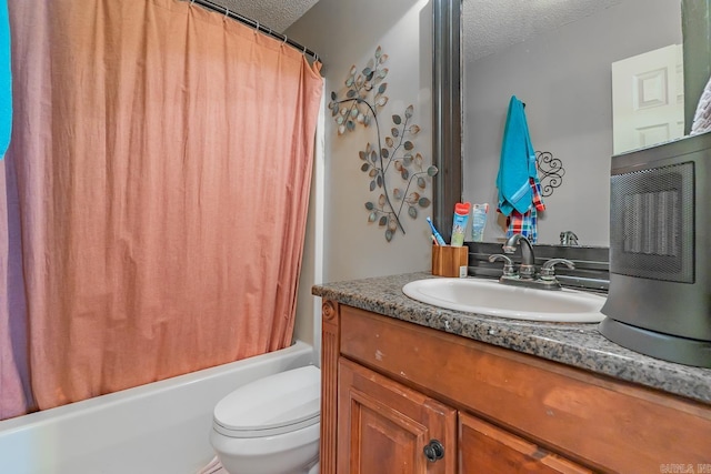 bathroom with shower / bath combo with shower curtain, a textured ceiling, toilet, and vanity