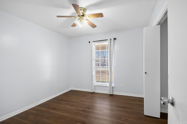 unfurnished room with a ceiling fan, dark wood finished floors, and baseboards