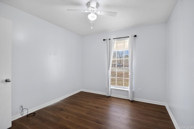 unfurnished room featuring dark wood-style floors, a textured ceiling, baseboards, and a ceiling fan