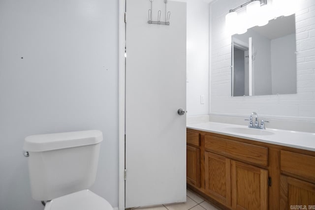 bathroom with vanity, toilet, and tile patterned floors