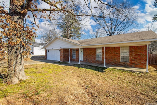 ranch-style home featuring a garage, concrete driveway, brick siding, and a front yard