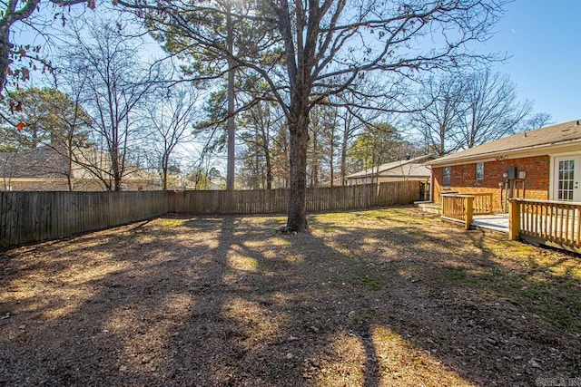 view of yard featuring a fenced backyard and a deck