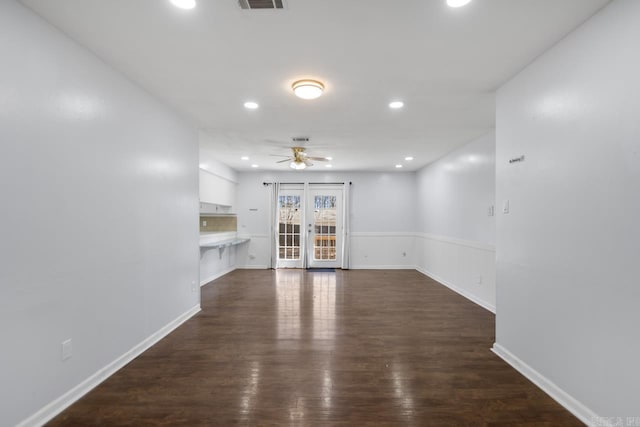 unfurnished living room with ceiling fan, recessed lighting, visible vents, french doors, and dark wood finished floors