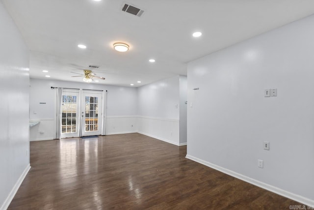 empty room featuring recessed lighting, visible vents, a ceiling fan, wainscoting, and dark wood-style floors