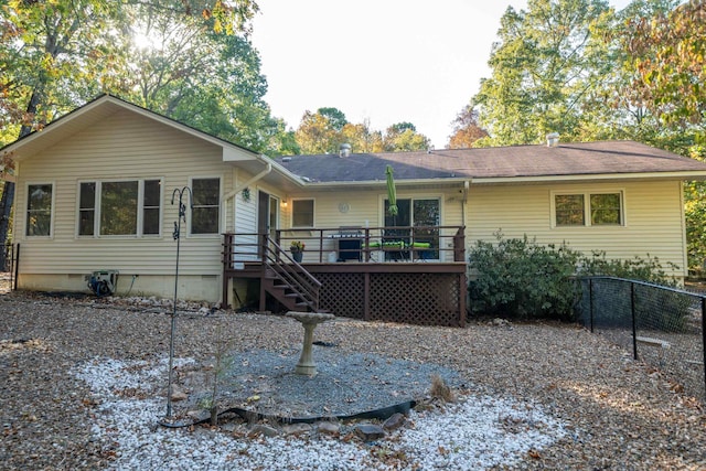 view of front of home with crawl space, fence, a wooden deck, and stairs