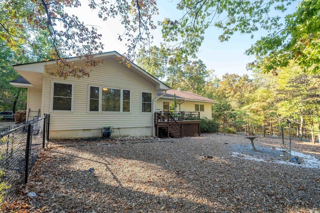 rear view of property with crawl space, stairway, fence, and a wooden deck