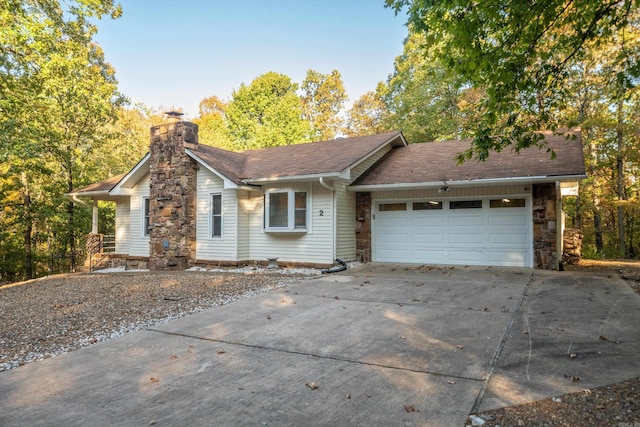 single story home with an attached garage, stone siding, driveway, and a chimney