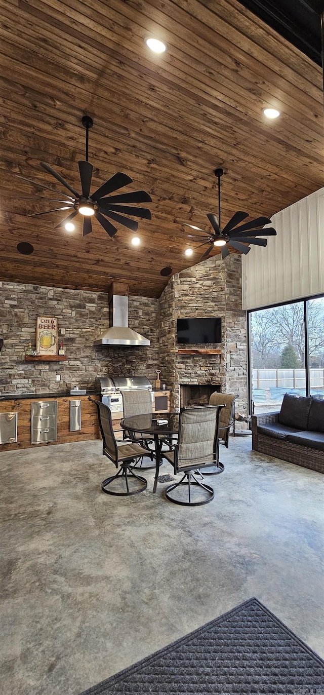 view of patio featuring grilling area, ceiling fan, outdoor dining area, and an outdoor kitchen