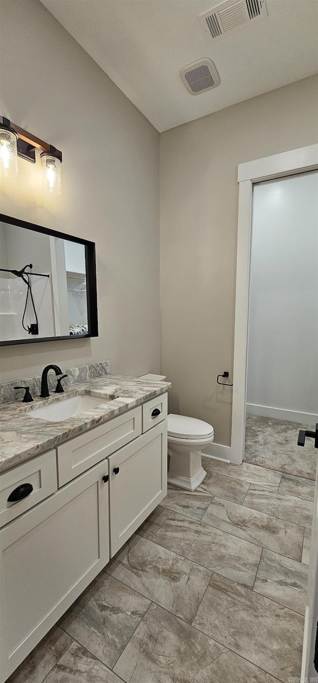 bathroom with toilet, baseboards, visible vents, and vanity