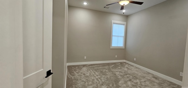 empty room featuring carpet floors, baseboards, visible vents, and a ceiling fan