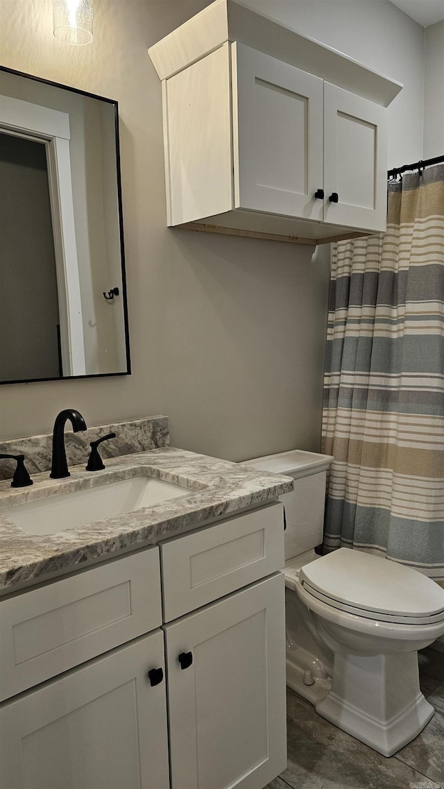 full bath featuring toilet and vanity