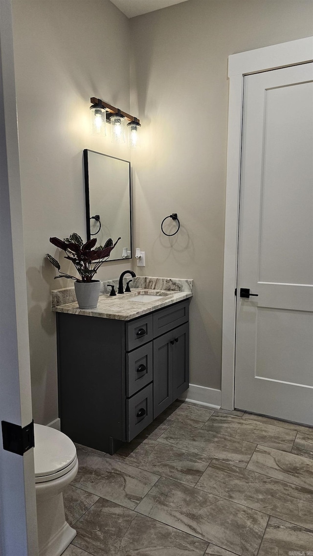 bathroom featuring toilet and vanity