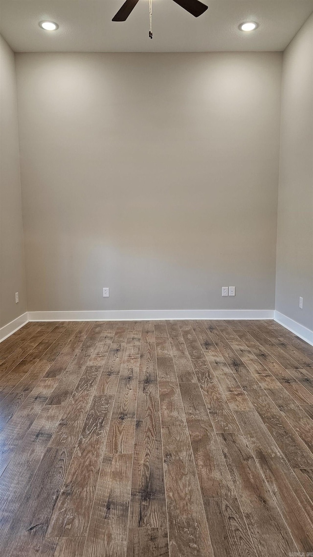 spare room featuring dark wood-style flooring, recessed lighting, a ceiling fan, and baseboards