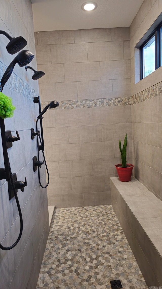 bathroom with tiled shower