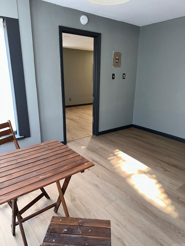 interior space featuring light wood finished floors and baseboards