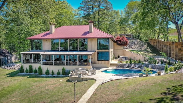 201 Lazy Ln, Hot Springs, AR 71913 - back of house featuring a chimney, a fenced backyard, a yard, a fenced in pool, and a patio