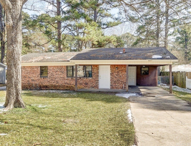 ranch-style home featuring brick siding, a front yard, and fence