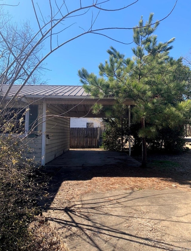 860 Ash St, Prescott, AR 71857 - view of parking / parking lot with driveway, an attached carport, and fence