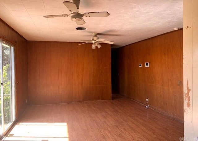 860 Ash St, Prescott, AR 71857 - unfurnished room with ceiling fan, wooden walls, and wood finished floors