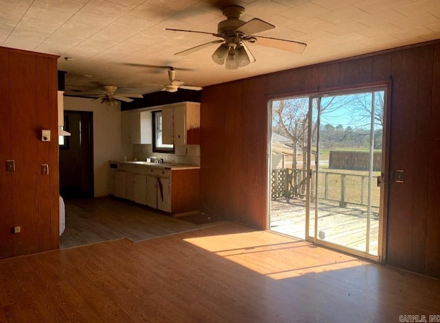 860 Ash St, Prescott, AR 71857 - kitchen featuring a ceiling fan, light wood-type flooring, light countertops, and wooden walls