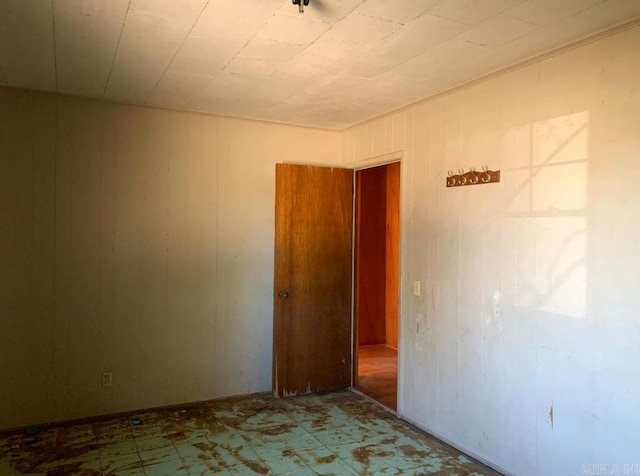860 Ash St, Prescott, AR 71857 - spare room with wood walls and tile patterned floors