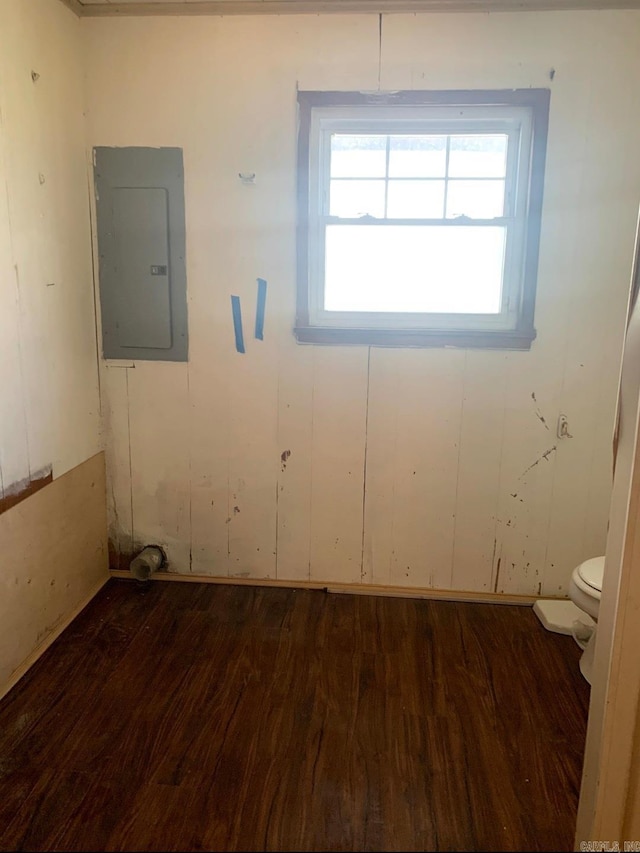 860 Ash St, Prescott, AR 71857 - empty room featuring electric panel and dark wood finished floors