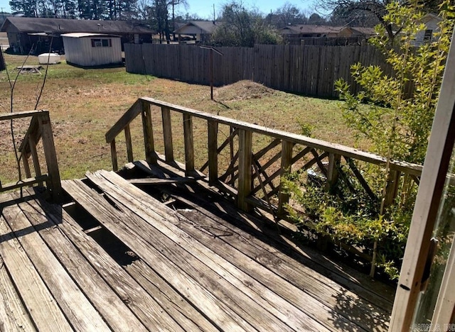 860 Ash St, Prescott, AR 71857 - wooden terrace with a shed, a lawn, an outdoor structure, and a fenced backyard