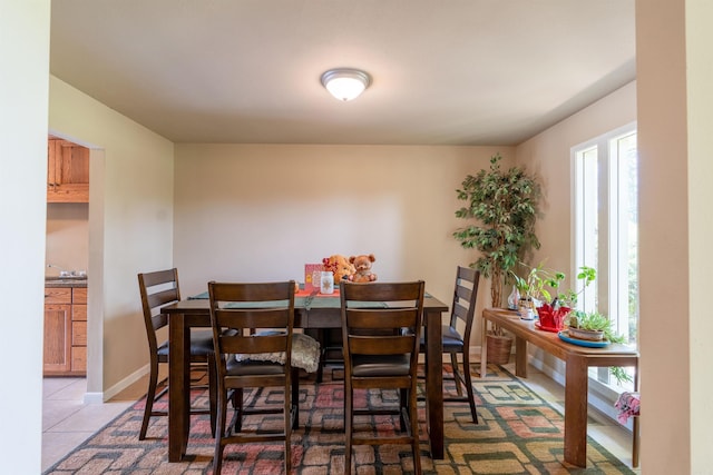 dining room with light tile patterned floors and baseboards