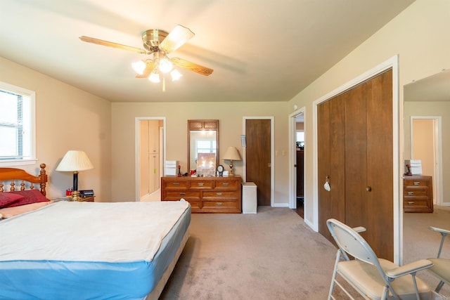 bedroom with light carpet, ceiling fan, and baseboards