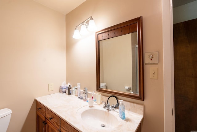 bathroom featuring vanity and toilet