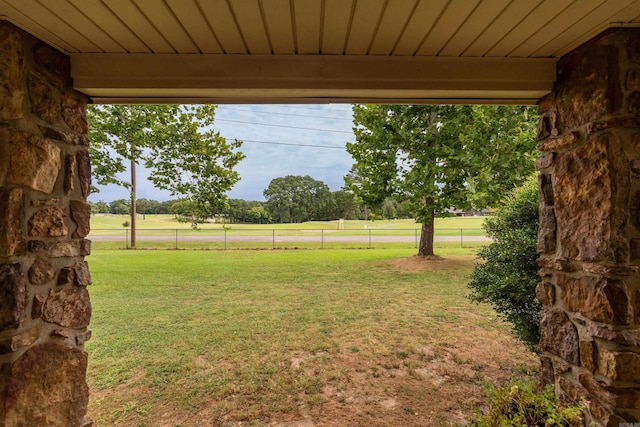 view of yard featuring a rural view and fence