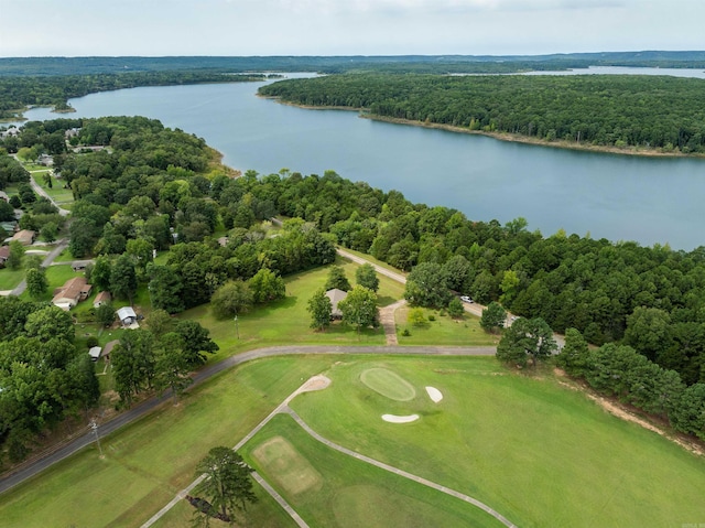 drone / aerial view featuring a water view, a wooded view, and golf course view