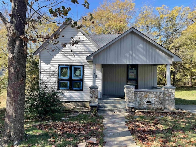 view of front facade with a porch and roof with shingles