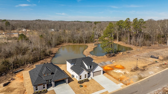 birds eye view of property with a wooded view